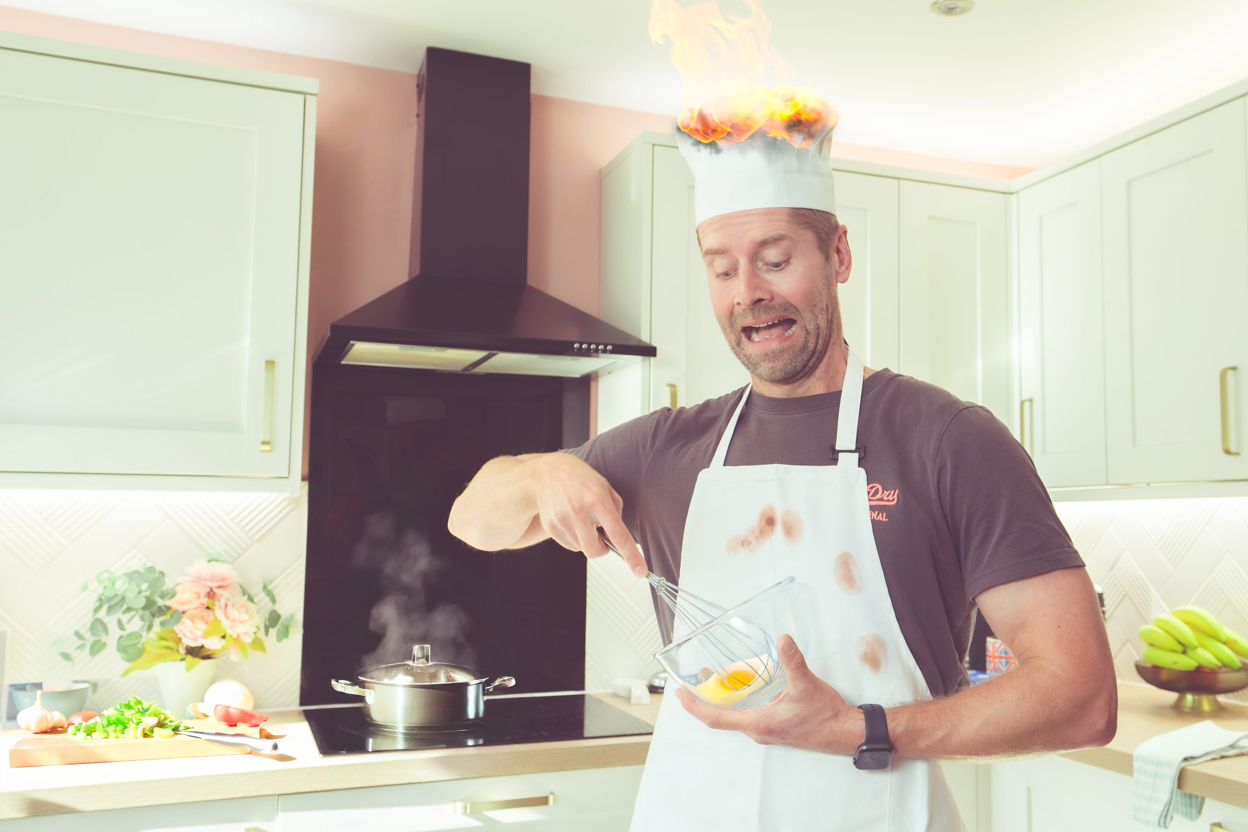 Healthy eating made simple- A man struggles in a chaotic kitchen environment, implying everyone struggles when they first start out.  