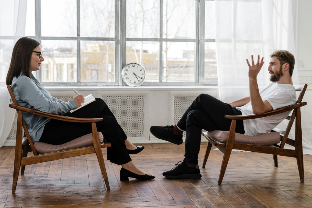 A man and woman sit in a calm environment, discussing the importance of mental health